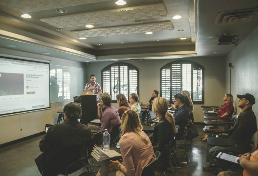 An audience listening to a speaker in a seminar room